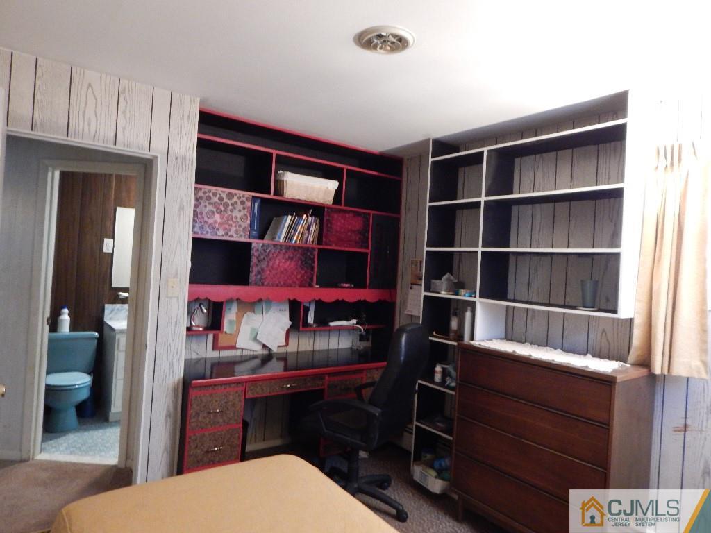 11 Dobson Road Edison, NJ 08817 - Photo 11 of 16 a room with furniture a rug and a bookshelf