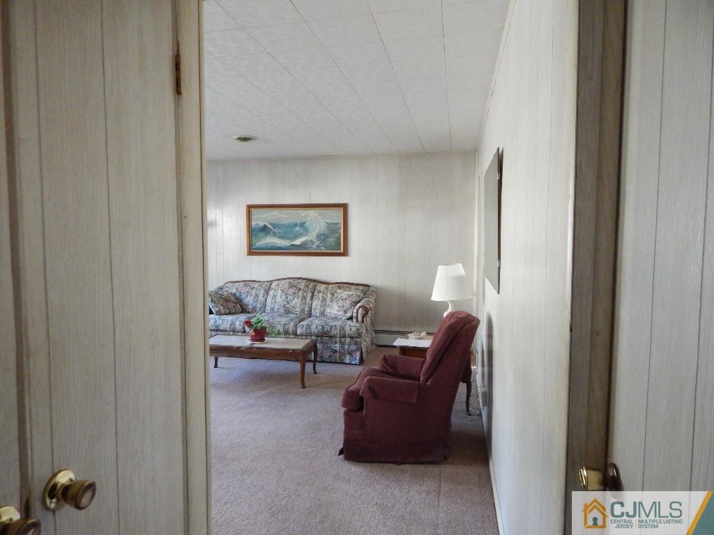 11 Dobson Road Edison, NJ 08817 - Photo 14 of 16 a living room with furniture and a painting on the wall