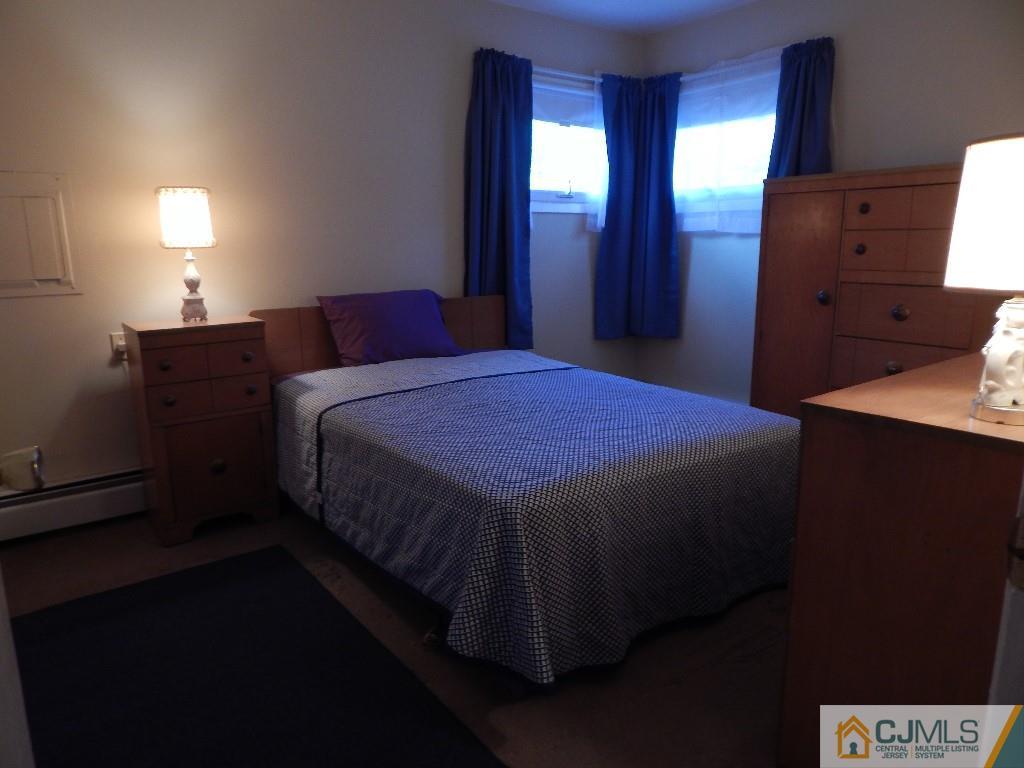 11 Dobson Road Edison, NJ 08817 - Photo 6 of 16 a bedroom with a bed and a lamp