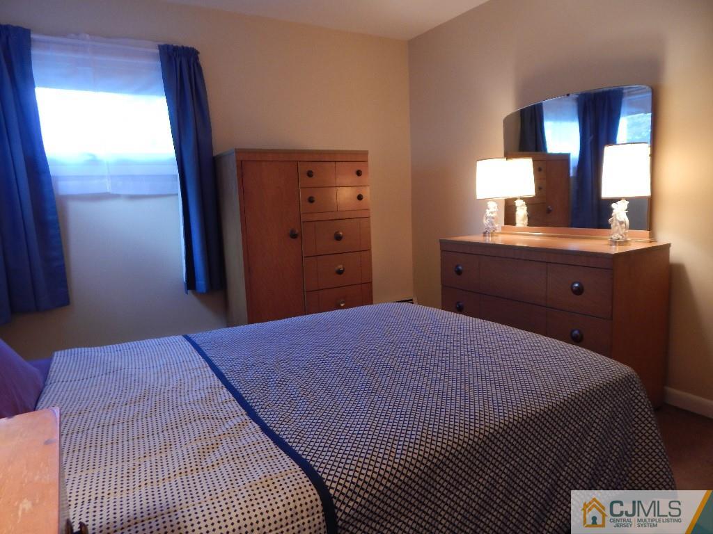 11 Dobson Road Edison, NJ 08817 - Photo 7 of 16 a bedroom with a bed and a dresser