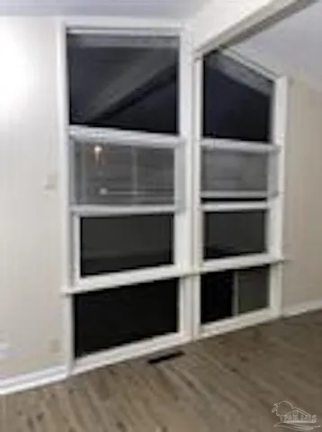 a living room with a fireplace and a ceiling fan