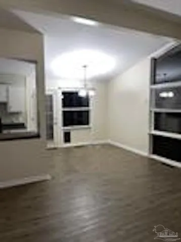 a view of a room with wooden floor