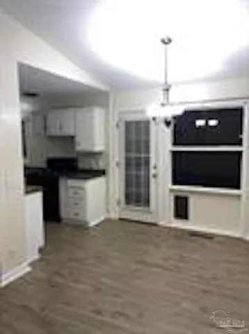 a view of a kitchen with a sink and cabinets