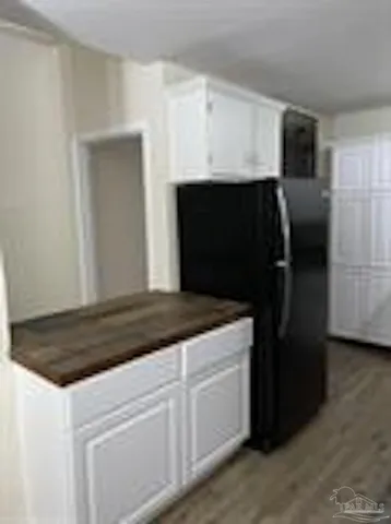 a kitchen with a refrigerator and a sink