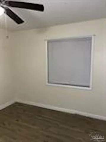 a view of a small space with wooden floor and a window