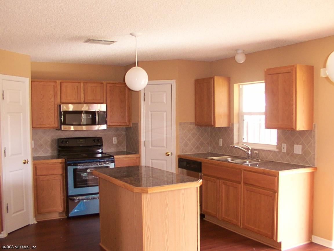 7316 Spring Hill Road Jacksonville, FL 32244 - Photo 6 of 11 a kitchen that has a sink and a stove in it