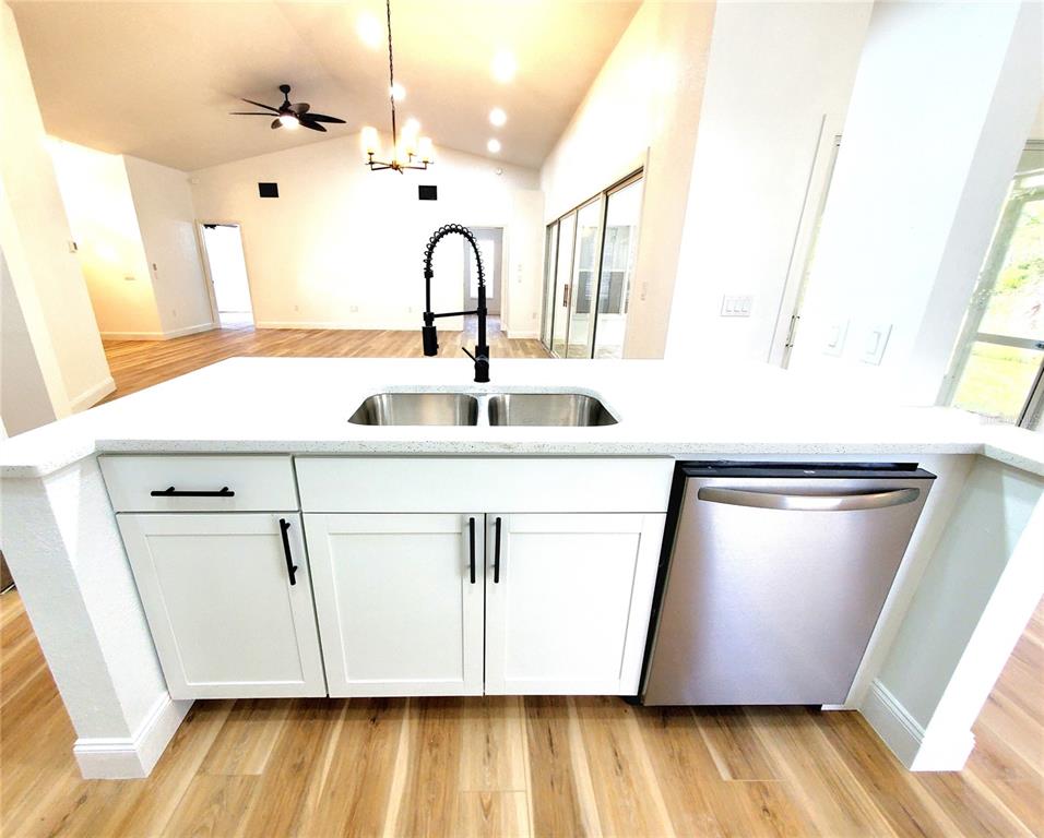1517 Morning Rose Place Trinity, FL 34655 - Photo 15 of 50 a close view of a sink a washer and dryer with wooden floor