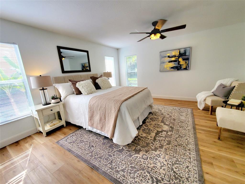 1517 Morning Rose Place Trinity, FL 34655 - Photo 22 of 50 a bedroom with a bed and wooden floor