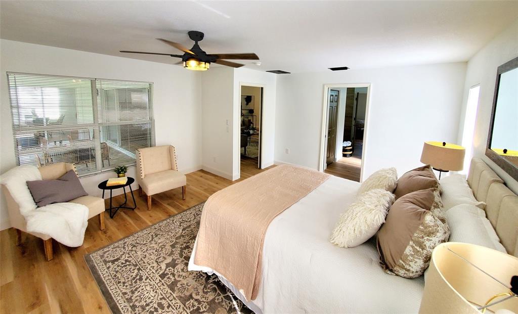 1517 Morning Rose Place Trinity, FL 34655 - Photo 23 of 50 a spacious bedroom with a bed and glass table