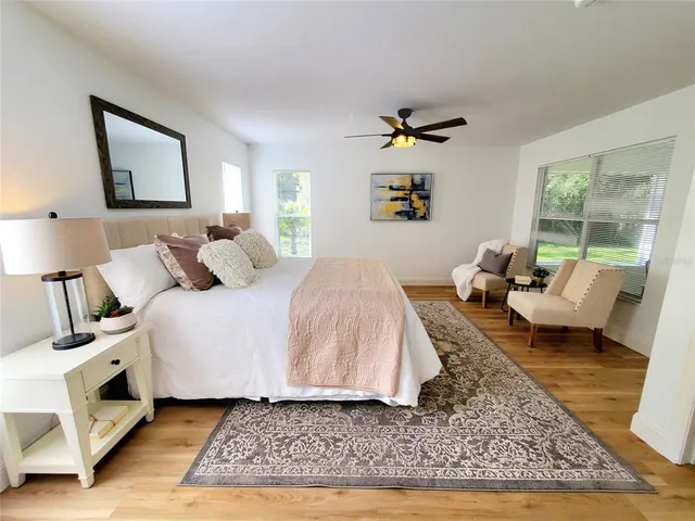 a spacious bedroom with a bed a couch and a window