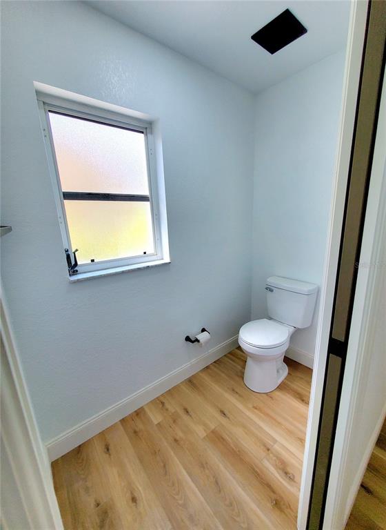 1517 Morning Rose Place Trinity, FL 34655 - Photo 31 of 50 a bathroom with a toilet sink and a mirror