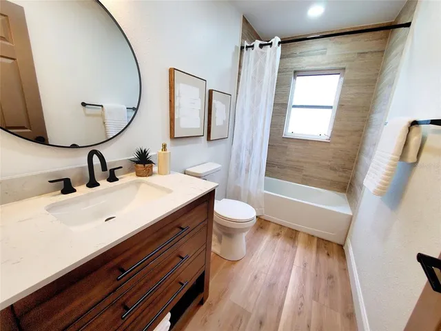 a bathroom with a sink mirror vanity and toilet
