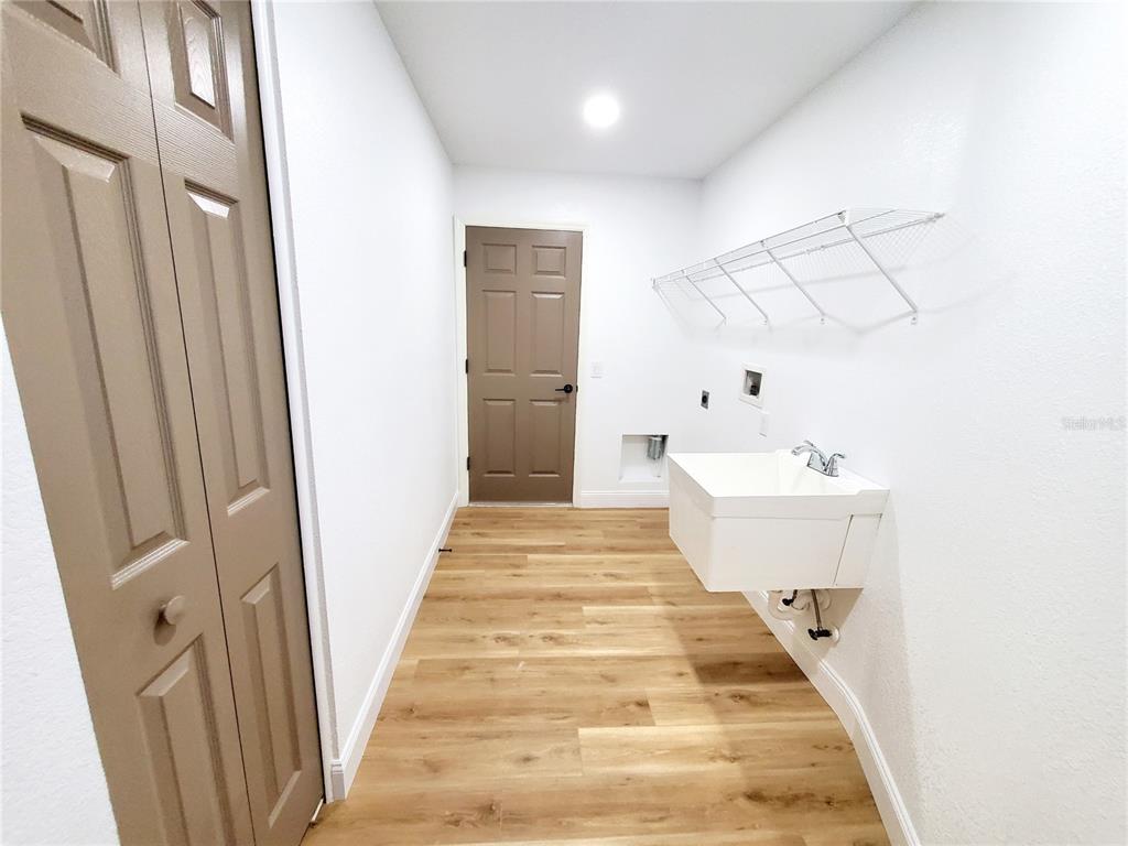 1517 Morning Rose Place Trinity, FL 34655 - Photo 40 of 50 a view of a hallway with wooden floor and staircase