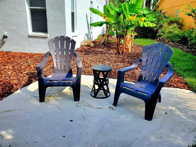 a view of a chairs and table in the garden