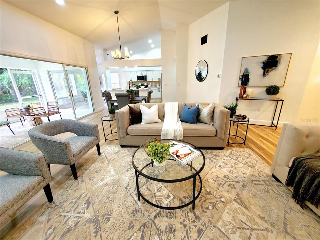 1517 Morning Rose Place Trinity, FL 34655 - Photo 8 of 50 a living room with furniture a rug and a floor to ceiling window