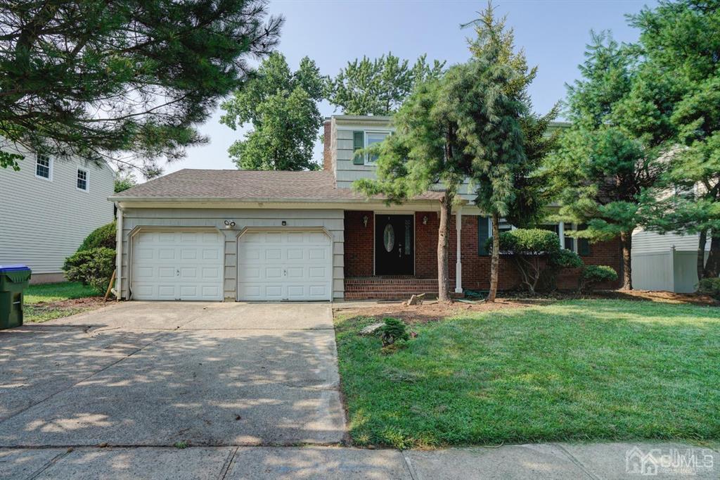 7 Calvert Avenue East Edison, NJ 08820 - Photo 1 of 47 a front view of a house with a yard and garage