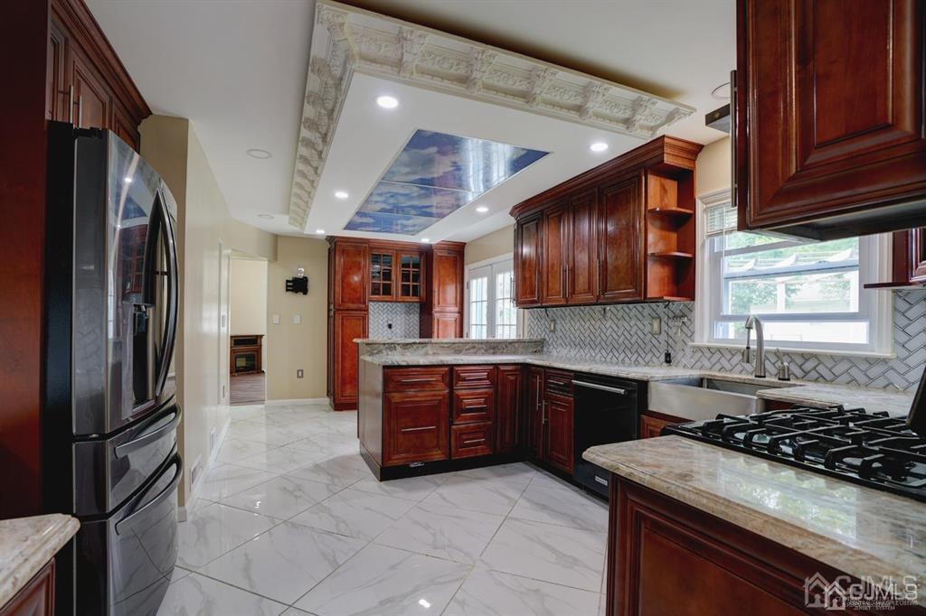 7 Calvert Avenue East Edison, NJ 08820 - Photo 11 of 47 a kitchen with stainless steel appliances granite countertop a stove top oven a sink and dishwasher