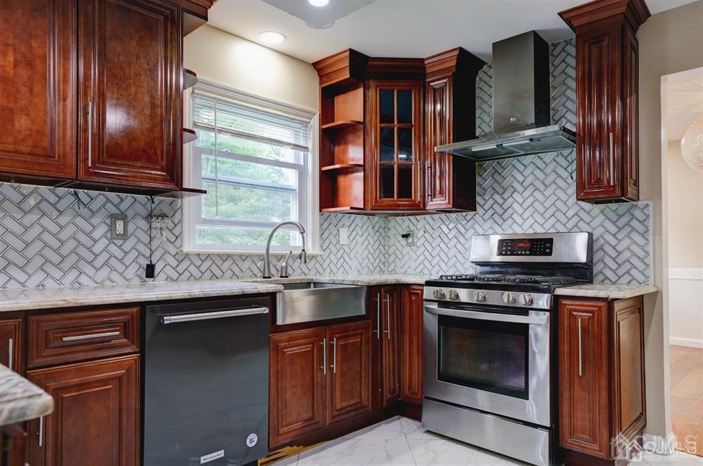 7 Calvert Avenue East Edison, NJ 08820 - Photo 17 of 47 a kitchen with stainless steel appliances granite countertop wooden cabinets stove top oven and sink