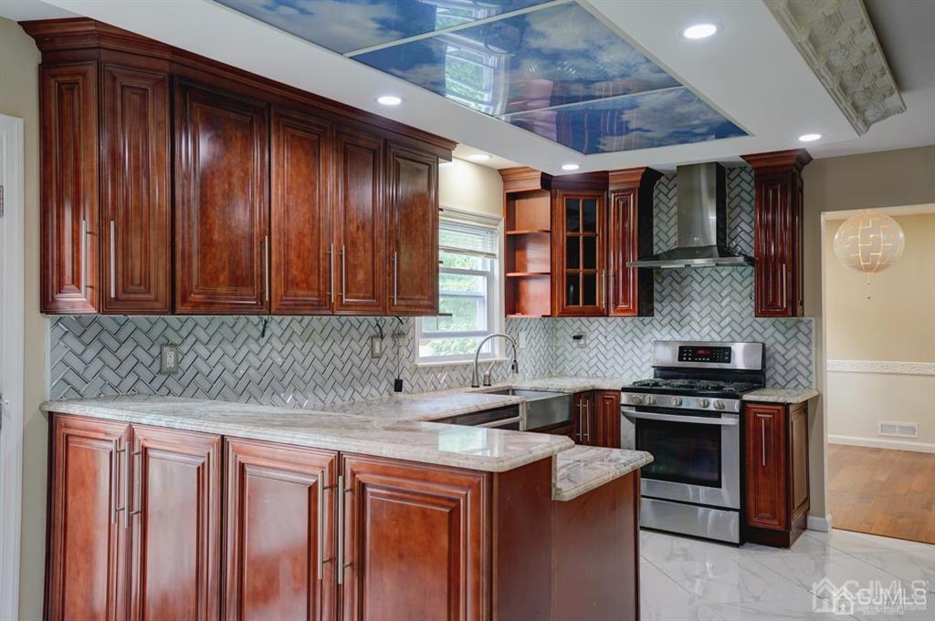 7 Calvert Avenue East Edison, NJ 08820 - Photo 18 of 47 a kitchen with stainless steel appliances granite countertop wooden cabinets a stove top oven a sink and dishwasher