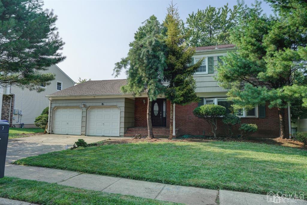 7 Calvert Avenue East Edison, NJ 08820 - Photo 2 of 47 a white house that has a small yard and large trees