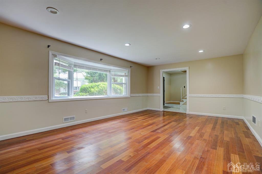 7 Calvert Avenue East Edison, NJ 08820 - Photo 24 of 47 a view of an empty room with wooden floor and a window