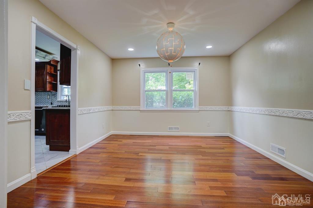 7 Calvert Avenue East Edison, NJ 08820 - Photo 26 of 47 a view of an empty room with wooden floor and a window