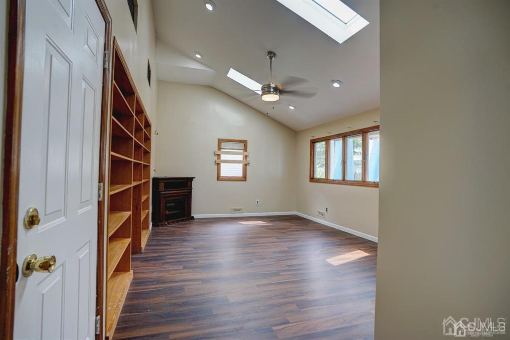 7 Calvert Avenue East Edison, NJ 08820 - Photo 28 of 47 an empty room with wooden floor and staircase