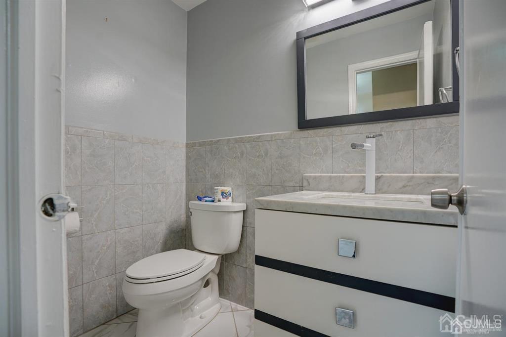 7 Calvert Avenue East Edison, NJ 08820 - Photo 30 of 47 a bathroom with a toilet a sink and mirror