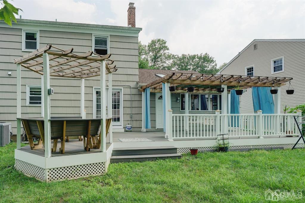 7 Calvert Avenue East Edison, NJ 08820 - Photo 6 of 47 a view of a house with a small deck and a garden