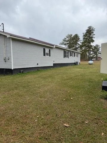 a view of a house with a backyard