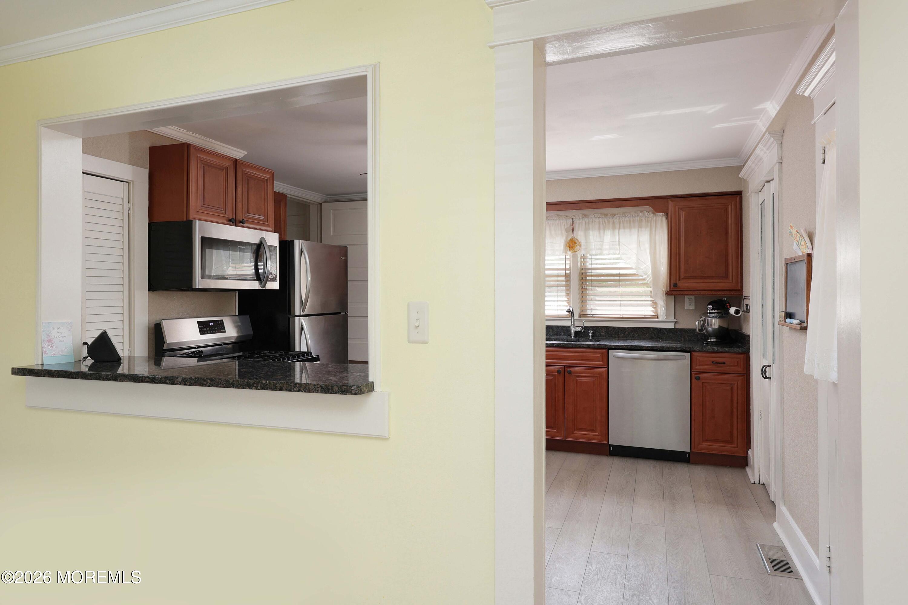 715 Howe Street Point Pleasant, NJ 08742 - Photo 9 of 45 a kitchen with stainless steel appliances granite countertop a stove a sink and a microwave