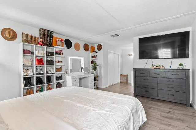 a bedroom with a bed and a flat screen tv