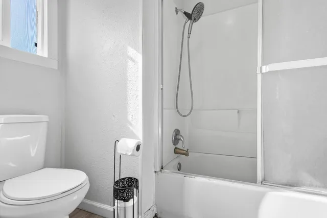 a bathroom with a toilet and a shower