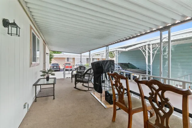 a view of a patio with table and chairs and potted plants