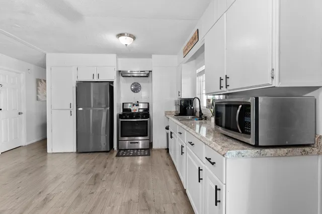 a kitchen with stainless steel appliances a refrigerator stove and sink