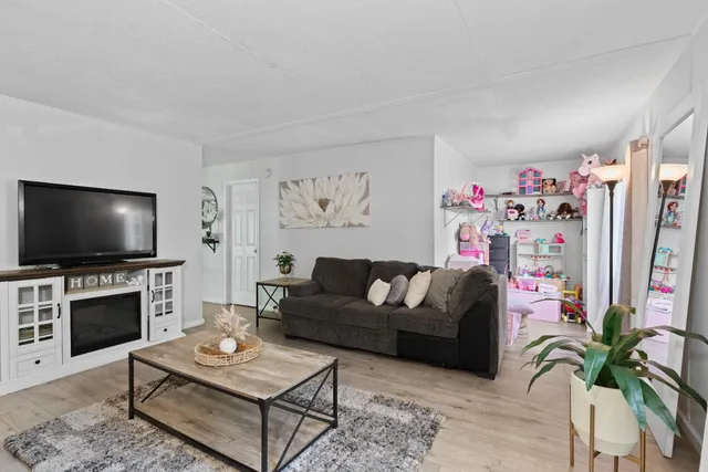 a living room with furniture and a flat screen tv