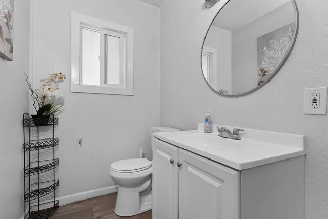 a bathroom with a sink a toilet and a mirror