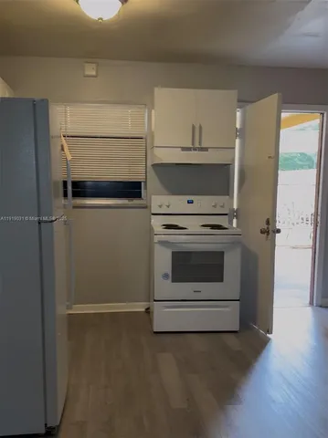 a kitchen with a stove and a refrigerator