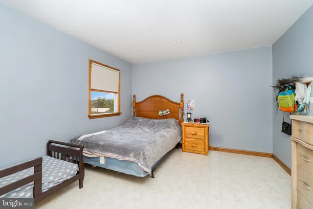 a large bed sitting in a room next to a cabinet