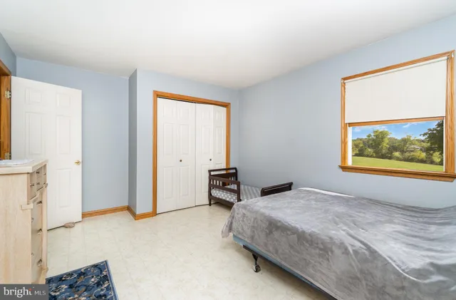 a bedroom that has a bed and a table in it