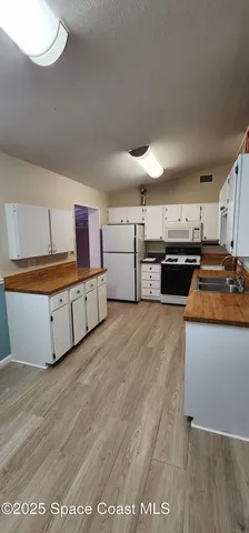 a kitchen with stainless steel appliances granite countertop a stove and a refrigerator