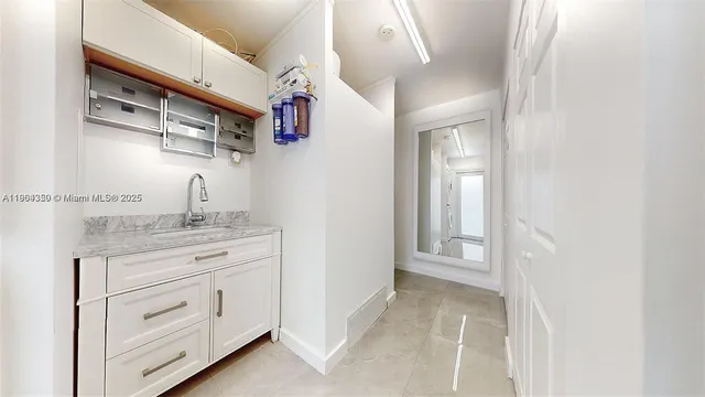 a bathroom with a granite countertop sink mirror and vanity