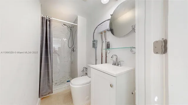 a bathroom with a sink toilet and shower