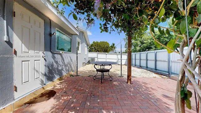 a view of a backyard with a tree