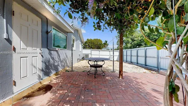 a view of backyard with sitting area