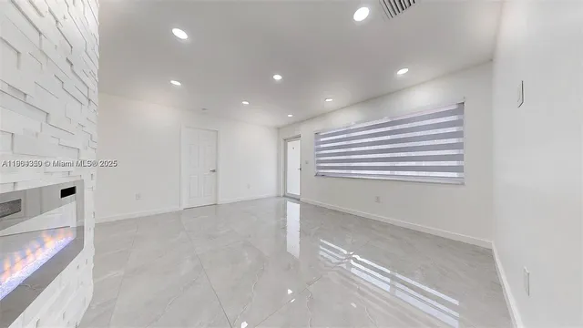 a view of an empty room with a window