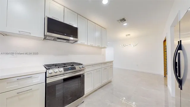 a kitchen with a microwave and a stove