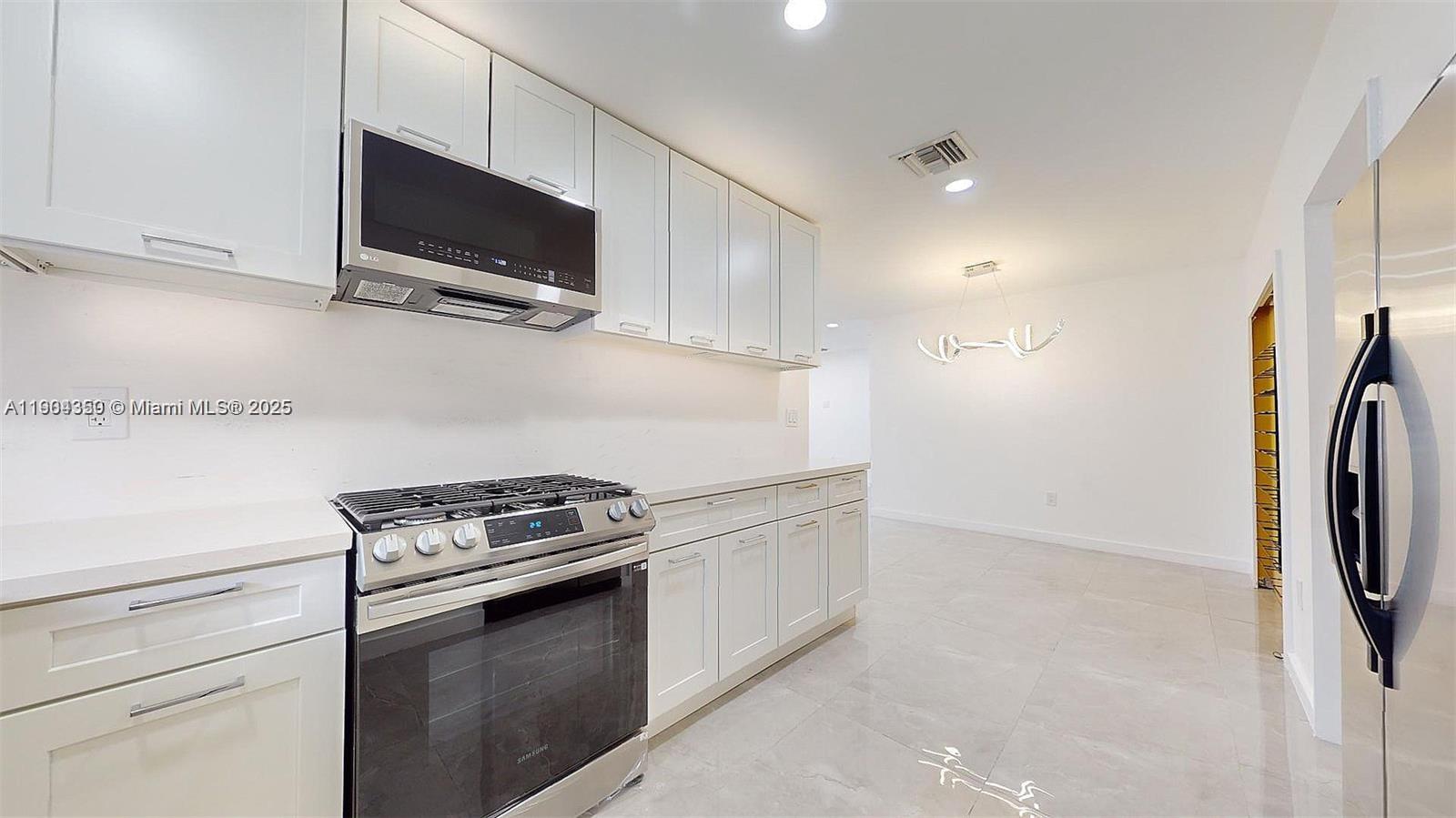 15704 Southwest 302nd Terrace Homestead, FL 33033 - Photo 6 of 26 a kitchen with a microwave and a stove