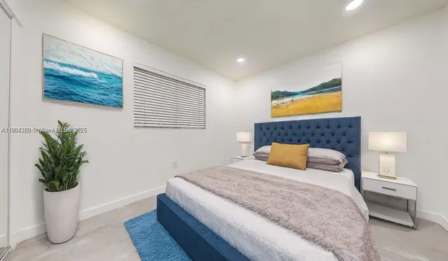 a bedroom with a bed and potted plant