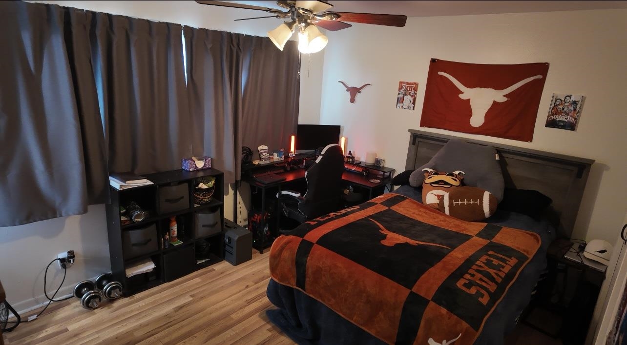 2709 Rice Avenue San Angelo, TX 76904 - Photo 14 of 28 a bedroom with a bed and wooden floor